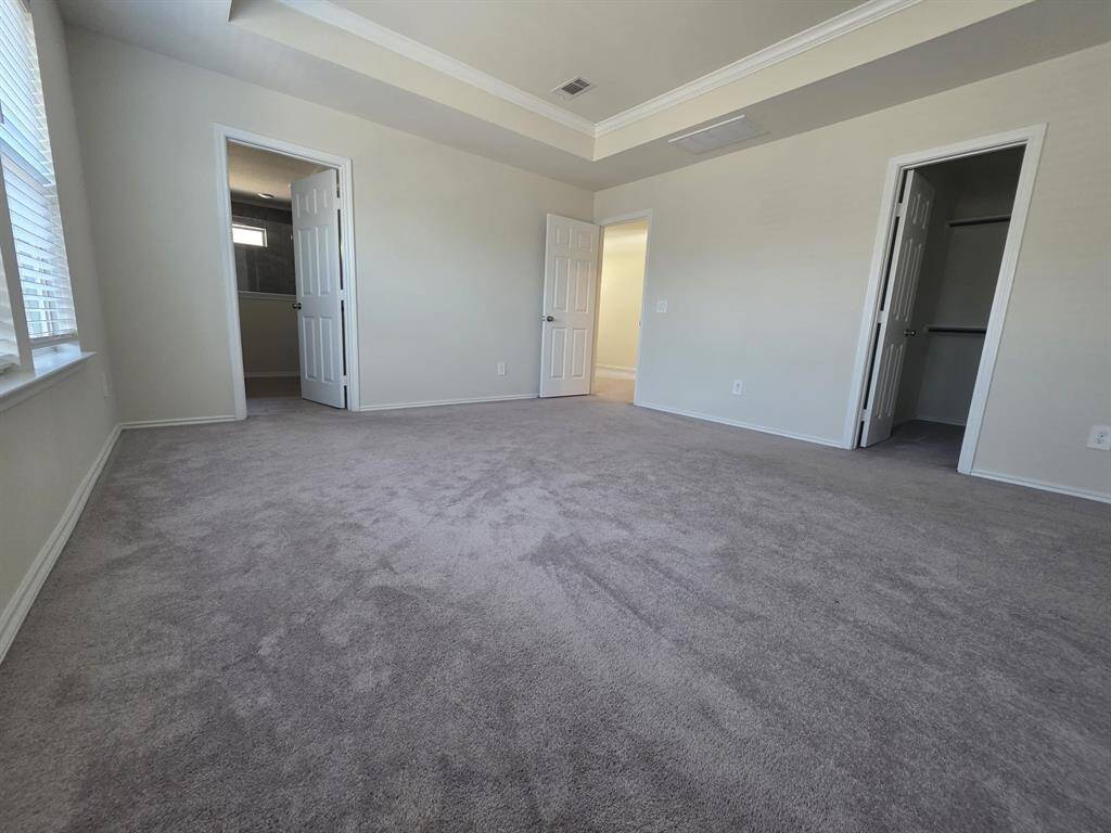 View of the master bedroom, it's walking closet and entrance to the ensuite bathroom.