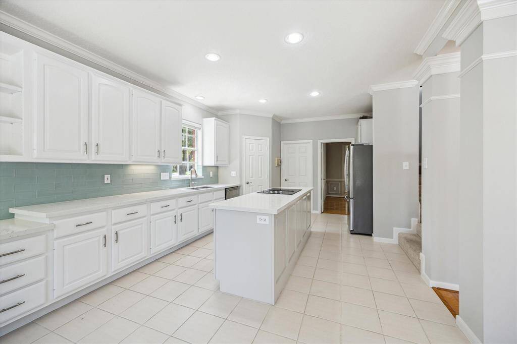 Enjoy Saturday morning pancakes and Wednesday night lasagna in this charming breakfast area, featuring stylish overhead lighting and a wall of windows with a glass patio door that offers beautiful views and easy access to the patio and pool.