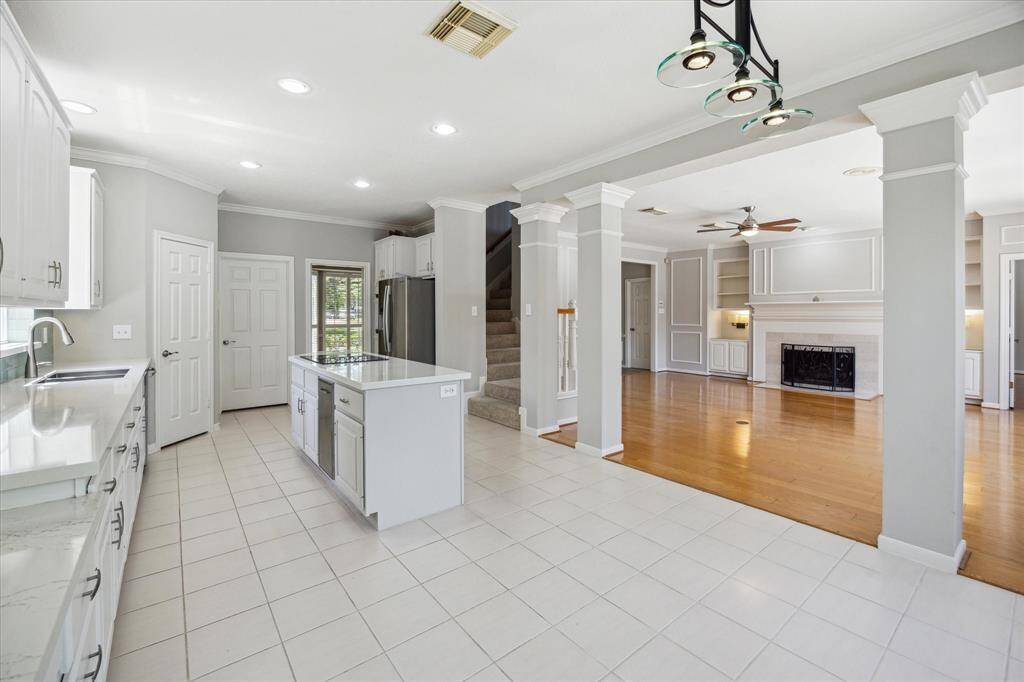 Ditch the takeout and fall in love with cooking again! This beautifully updated kitchen features sleek Quartz countertops, designer tile backsplash, crisp white cabinetry with pots and pans drawers, under-cabinet lighting, updated appliances, and a spacious pantry. With easy flow to both the casual breakfast area and elegant formal dining room, it makes everyday meals and special gatherings a breeze.