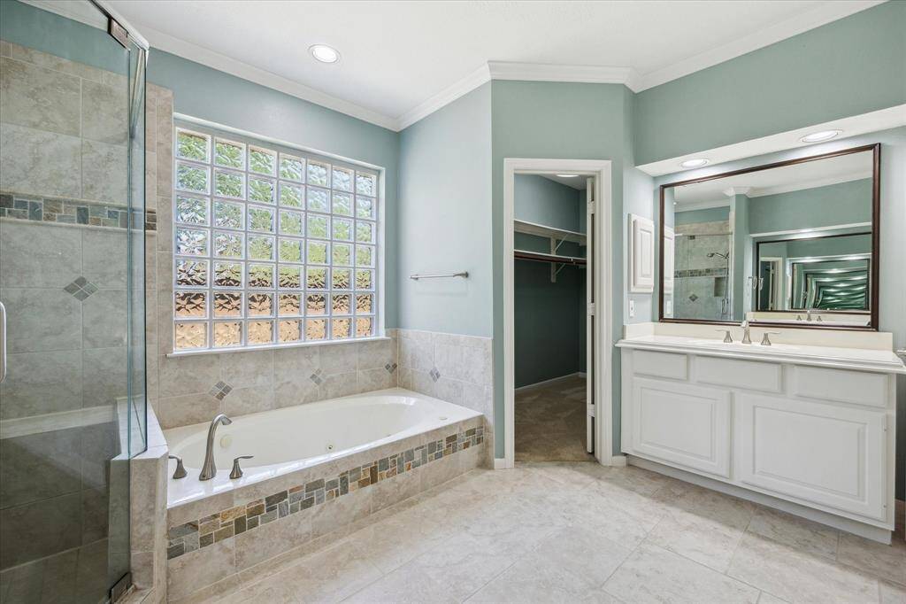 Wake up to views of the sparkling pool and spa, step outside for morning coffee on the patio, or simply enjoy the solitude of this private retreat. This light-filled owner's suite features bay windows, a glass patio door, rich hardwood floors, a custom walk-in closet, and a luxurious ensuite bath designed for comfort and relaxation.