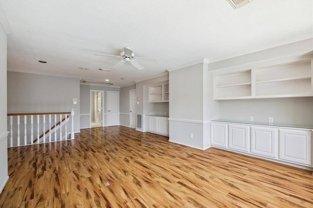 Designed with entertainment in mind, this expansive game room offers plenty of space for a game table, big screen, and comfortable seating. Warm wood-look flooring, neutral tones, and built-in cabinetry add both style and function, creating an inviting space perfect for movie nights, game days, or simply relaxing with friends and family.