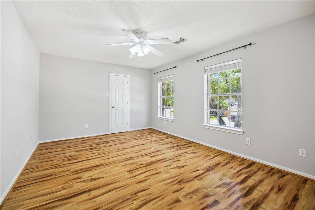 This spacious upstairs game room is the perfect spot for movie marathons, game nights, or casual lounging. It features rich wood-look flooring, fresh neutral paint, and custom built-ins for storing games, gear, or your favorite entertainment setup—ready for fun at a moment’s notice.
