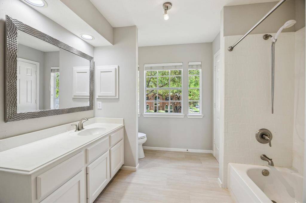 Another spacious guest room offers a comfortable retreat for family and visitors, featuring soft neutral finishes, a large closet, and ensuite access to a full bathroom. With plenty of room to stretch out and relax, it’s the perfect space to unwind at the end of the day.