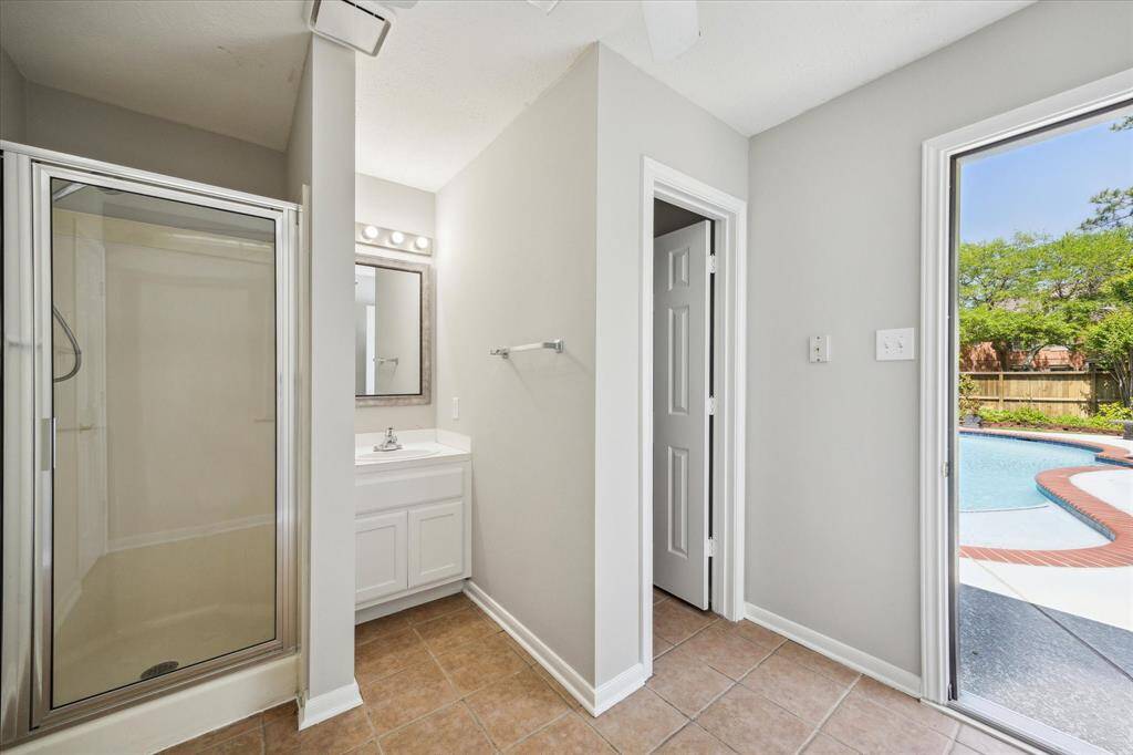 With two full bathrooms upstairs, morning routines are a breeze. This spotless bathroom features an extended single-sink vanity with a framed mirror and convenient medicine cabinet, along with a fully tiled tub/shower enclosure for added comfort and functionality.