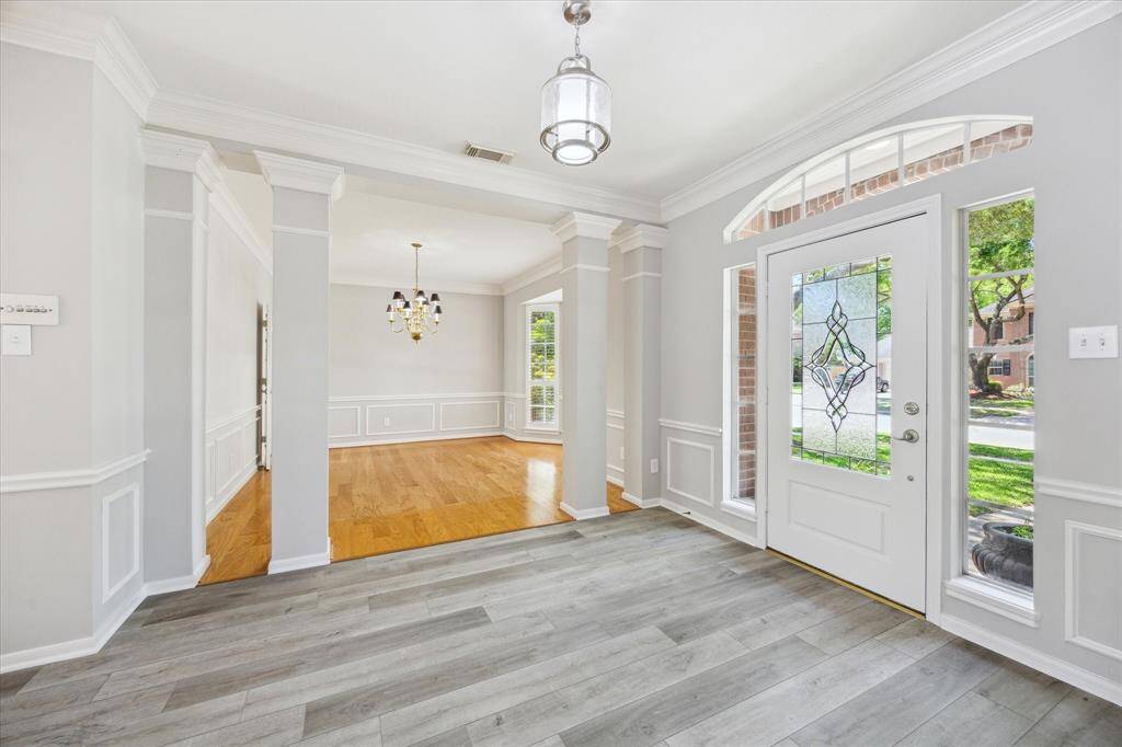 From the moment you arrive, this elegant entry makes a lasting impression. The arched transom and leaded-glass door open to a home filled with warmth, character, and timeless appeal inviting you to step inside and feel instantly at home.