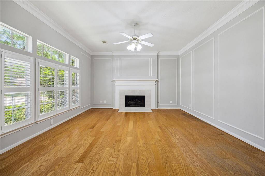 The foyer offers a lovely setting to greet visitors with luxury vinyl plank flooring, fresh neutral paint, thick crown molding, and elegant lighting, along with previews of the formal dining room to the right, a spacious study or formal living to the left, and an inviting family room directly ahead.