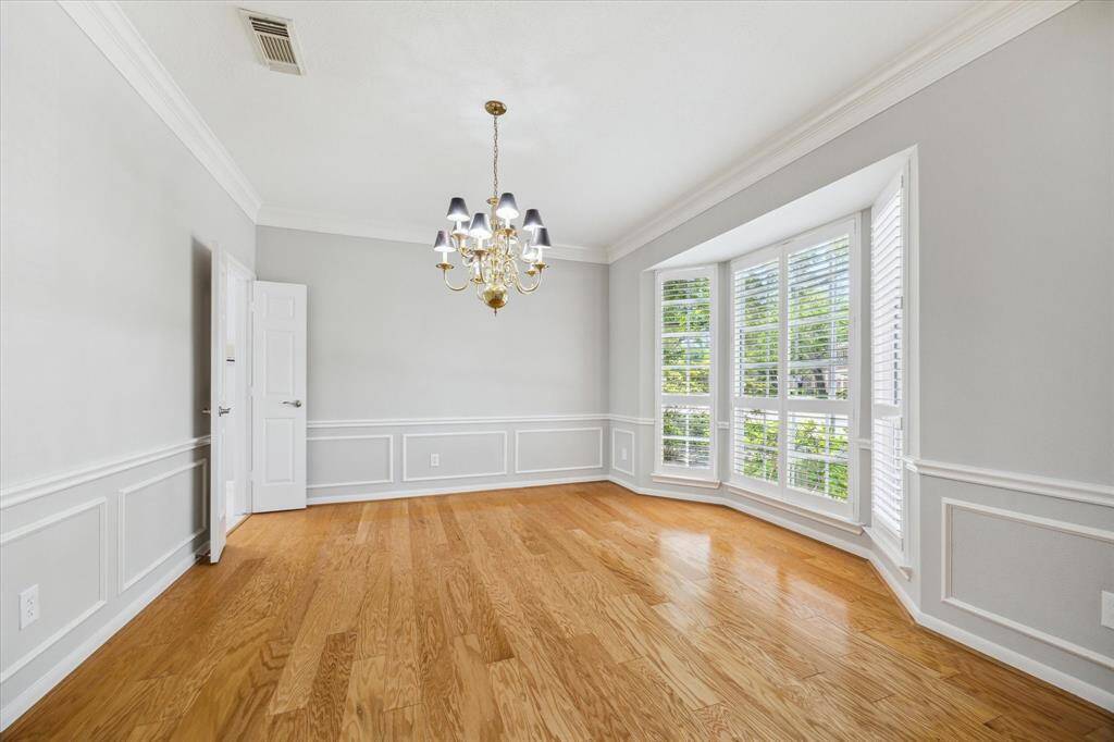 You’re going to love the morning commute to this spacious home office. This versatile floor plan offers the perfect space for a study or elegant formal living room, complete with gorgeous hardwood floors, neutral paint, picture and thick crown molding, wood-shuttered windows, and a cozy gas fireplace.