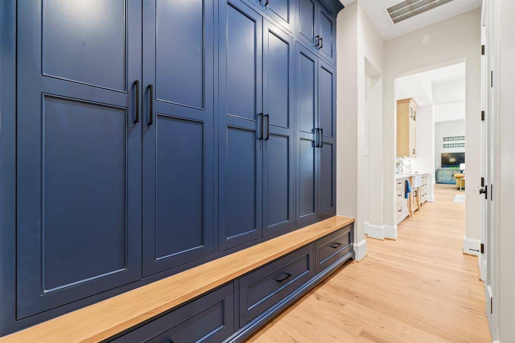 This photo showcases a hallway with elegant built-in cabinets for ample storage.