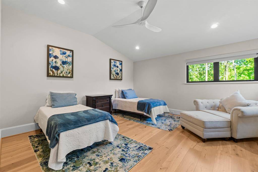 Bright and airy bedroom with a large window offers serene views.