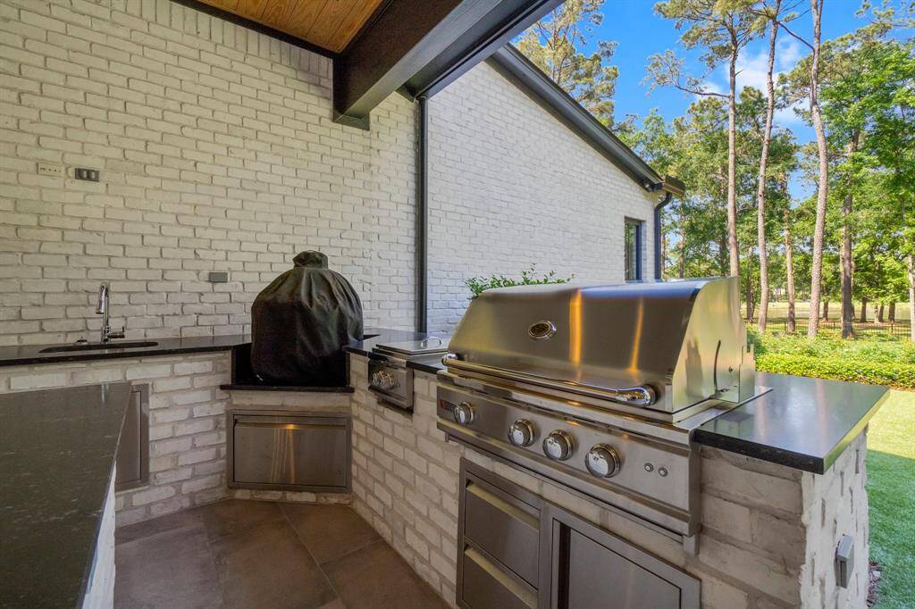 This outdoor kitchen features a sleek built-in grill and ample counter space, perfect for those who love entertaining