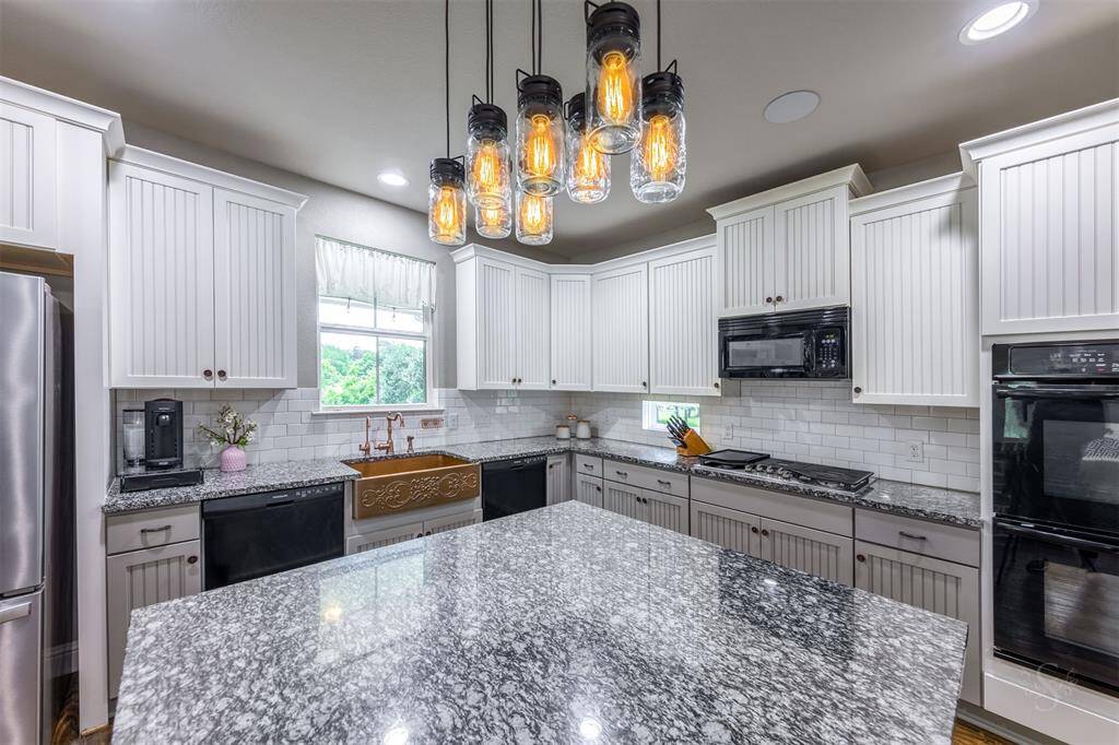 Notice the custom light fixture over the center island.