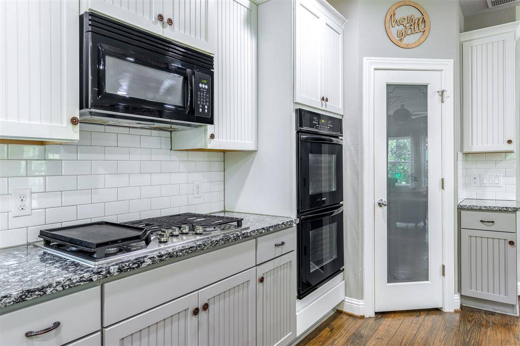Walk-in pantry with appliance shelf, electrical outlets, and a custom door.
