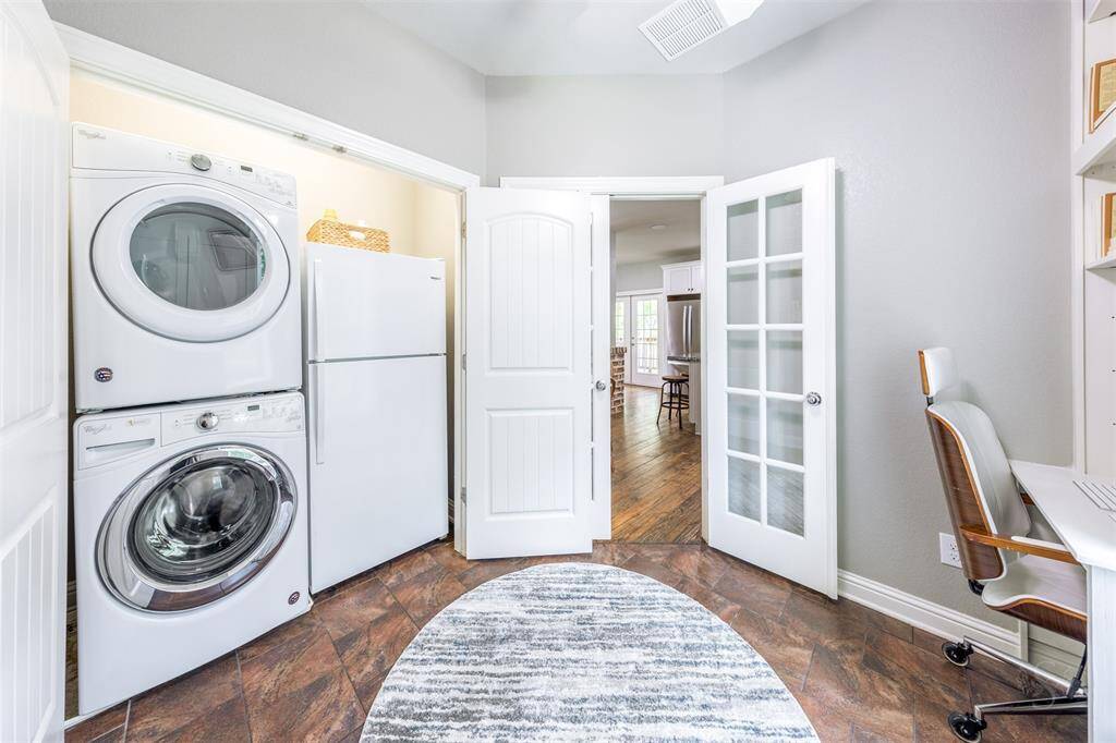 Located in the flex room is your first of 2 laundry rooms. This one has space for a second refrigerator.