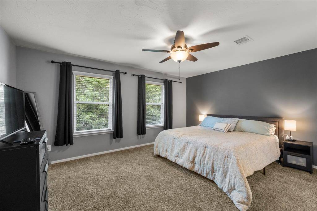 What a wonderful place to come home to! This stunning primary suite greets you with custom paint, plush carpet, bright natural light, and ceilinf fan!