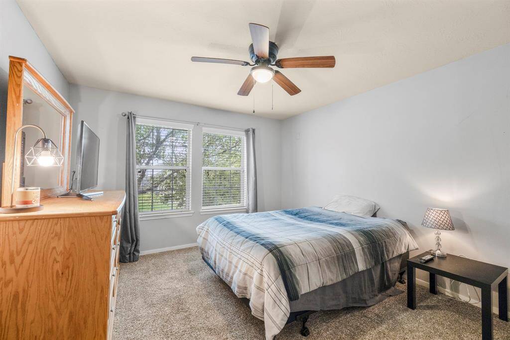 The final of the secondary bedrooms with a ceiling fan, plush carpet, netural paint, bright natural light, and a spacious closet.