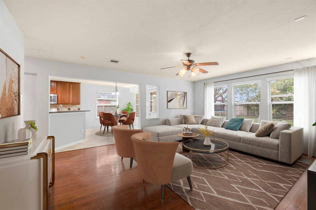 Walking in, you are greeted by a light and open space! This huge livingarea will not disappoint and offers an open layout, ceiling fan, wood floors, and large windows letting in tons of natural light. *This room has been virtually staged