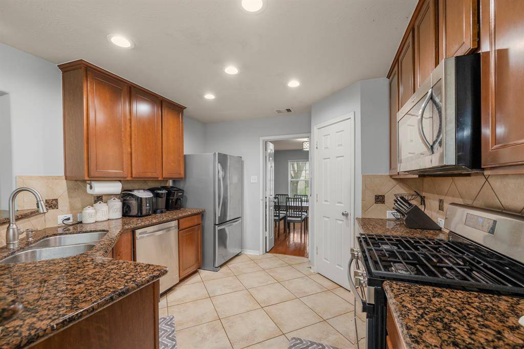 This kitchen will not disappoint! There is plenty of storage, granite countertops, a walk-in pantry, and recessed lighting.