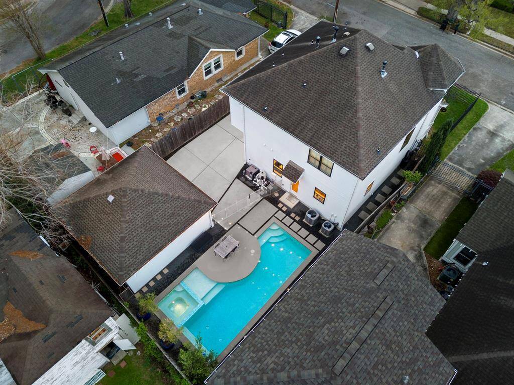 The backyard layout offers a seamless connection between the main home, detached garage, and gated driveway, with the pool and patio positioned to maximize usable space and privacy.
