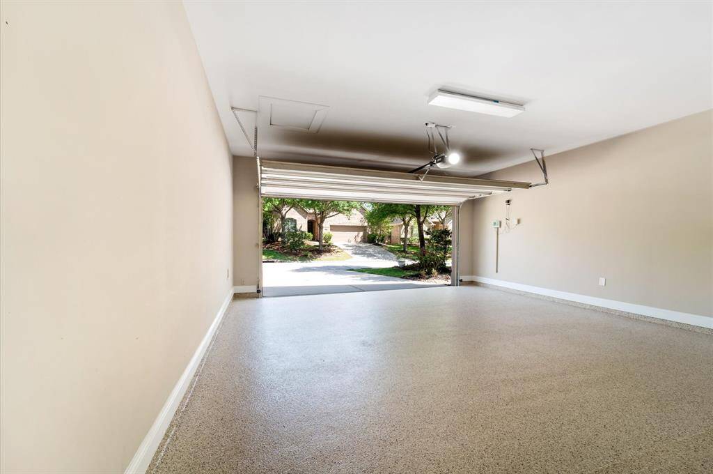 Spacious clean garage with a polished epoxy finish floor.