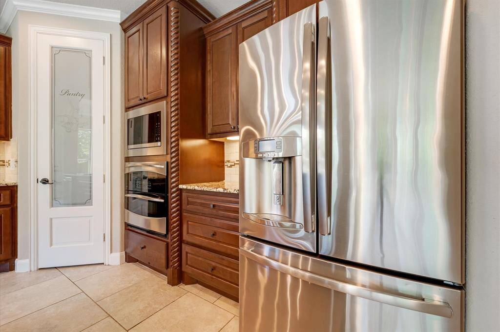 Stainless steel appliances, including a French door refrigerator and a new built-in microwave and double oven.