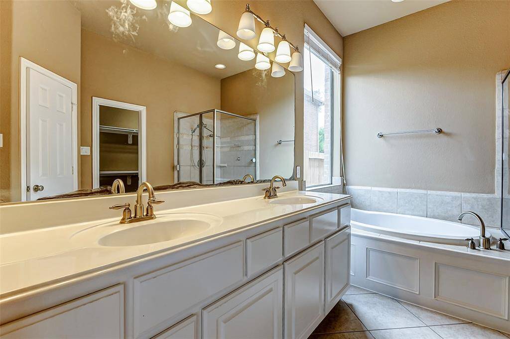 Elegant dual sinks offer convenience and style in this spacious bathroom.