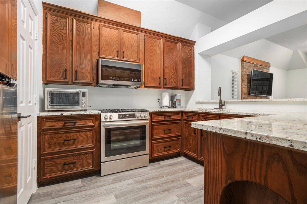 Granite countertops with plenty of cabinetry. Pantry is located to the left. Pots/Pans Drawers.