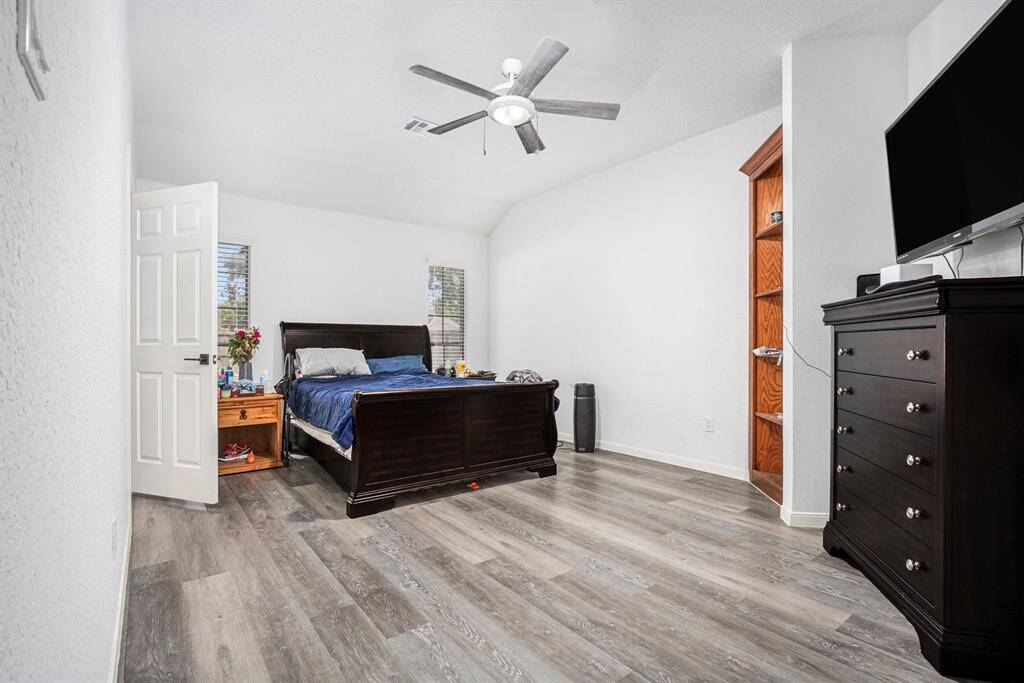 Primary bedroom with built in wood shelves.