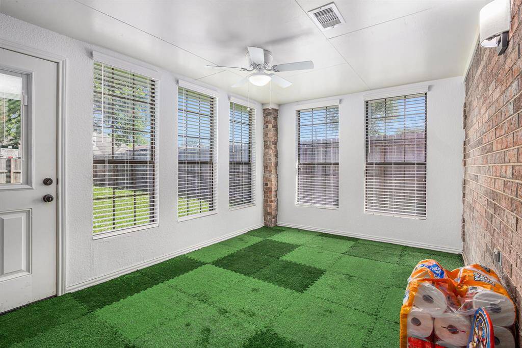 Covered patio was converted to a sunroom with artifical turf.