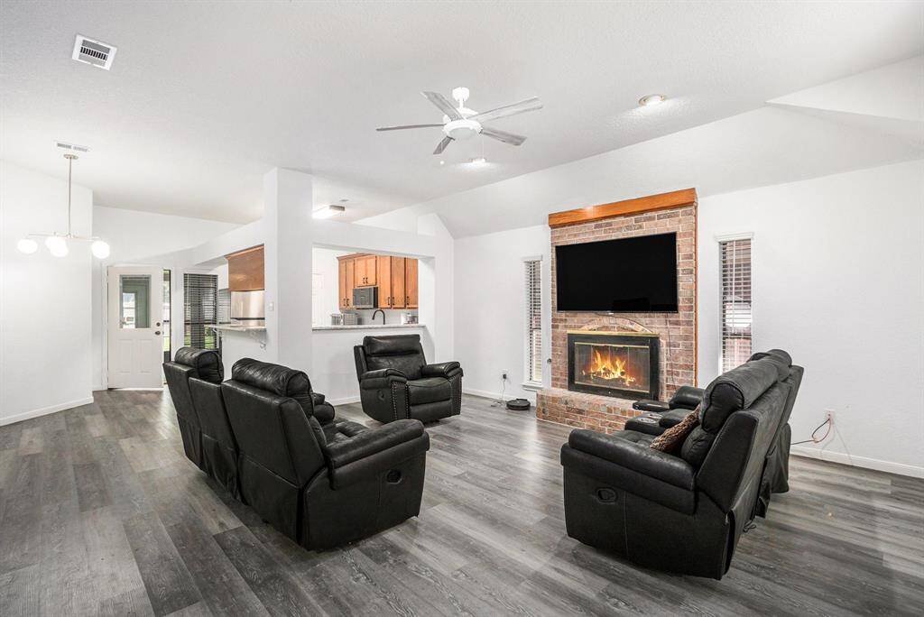 Upgraded vinyl plank throughout the home. Gas connection for the fireplace but will burn real wood.