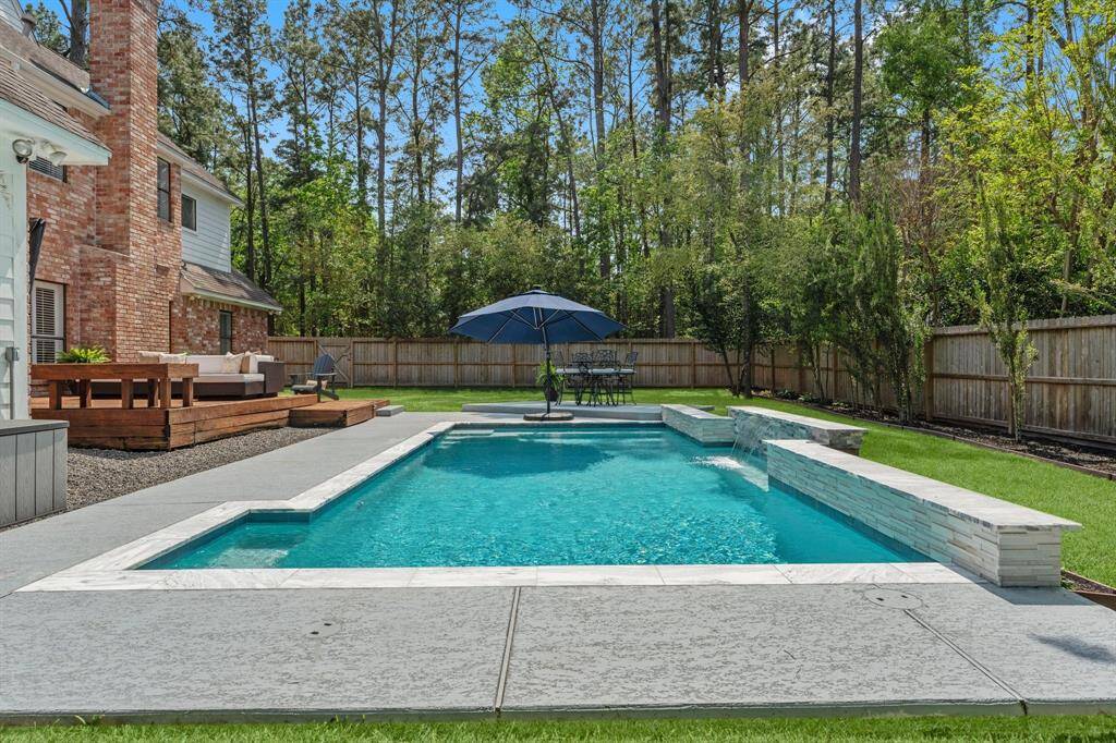 Stunning! Pool can be heated! Notice how the backyard is surrounded by so many mature trees!!