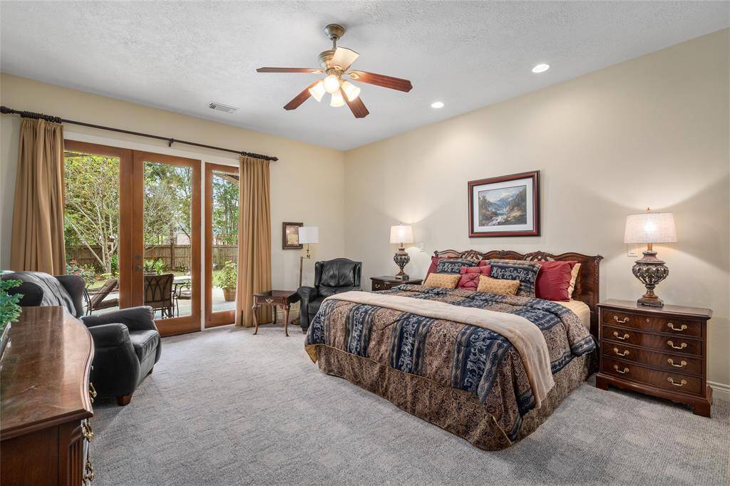 Step into the generously sized primary suite, with access to the back patio.