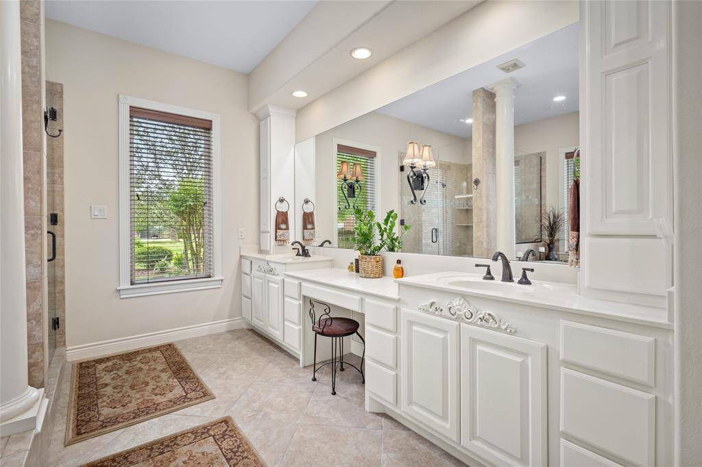 The primary bathroom features double sinks and a dedicated vanity area
