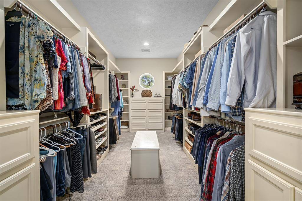 The primary closet offers plenty of space and storage, with built in drawers.