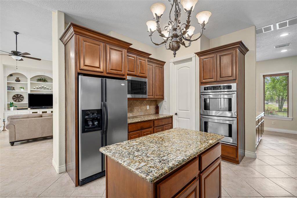 Stainless steel appliances complete the kitchen, offering a modern touch.