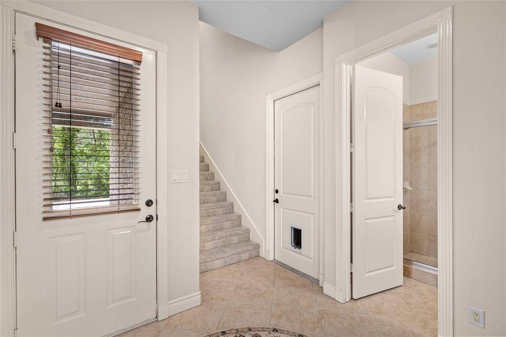 Connected to the side entry of the home is a full bath, garage access and a staircase that will take you to the huge gameroom/guest suite.