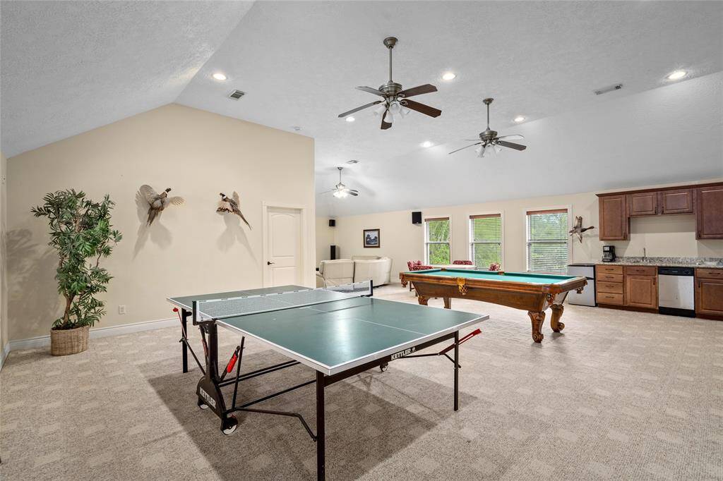 Extra large entertaining space, which could also be a guest suite, complete with a full bath and small kitchen. The doorway on the left leads you to a bedroom.