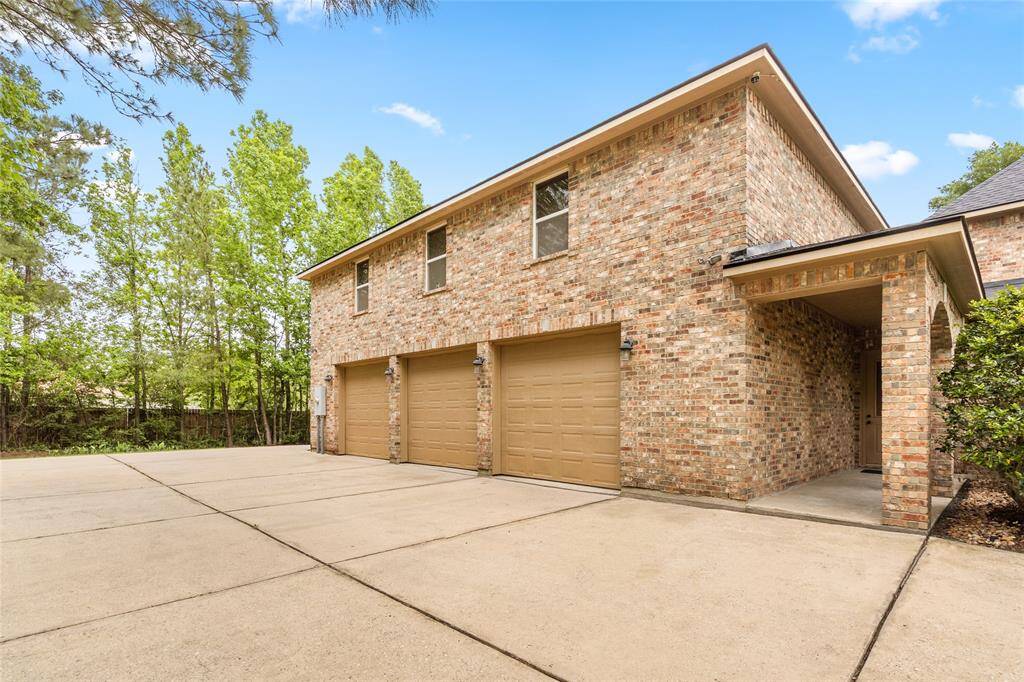 View of the extra large 4 car garage and drive way, plenty of parking options.