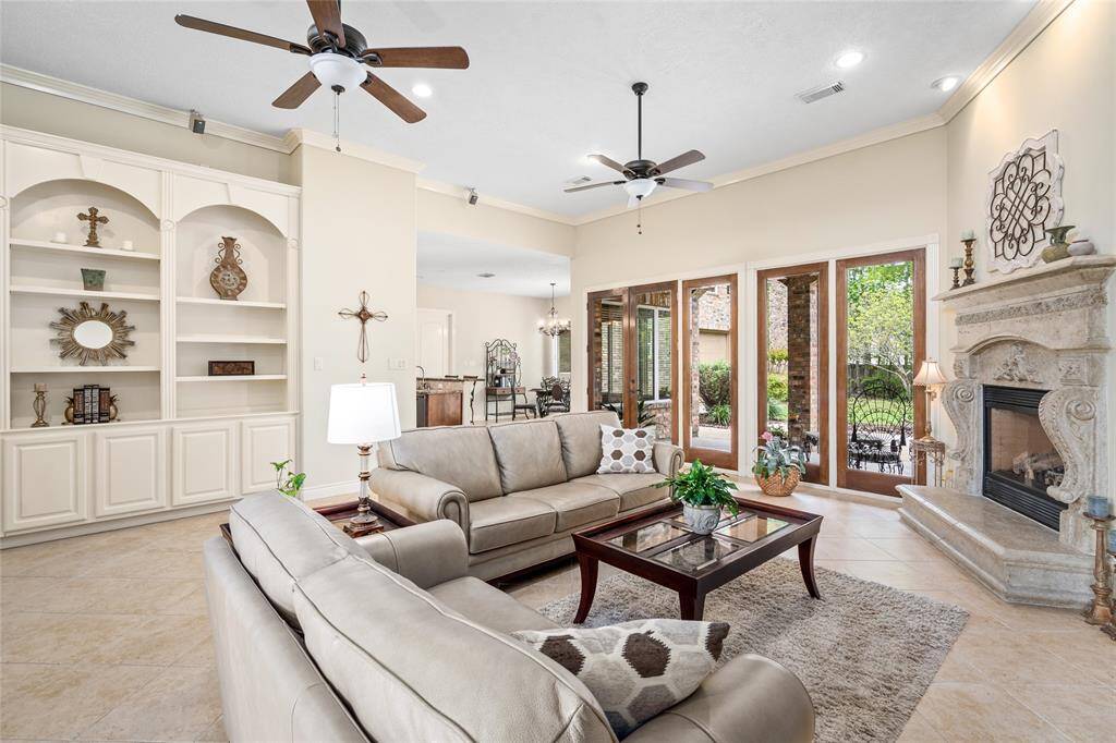 Enjoy the tall ceiling and built-in shelving throughout the living room.