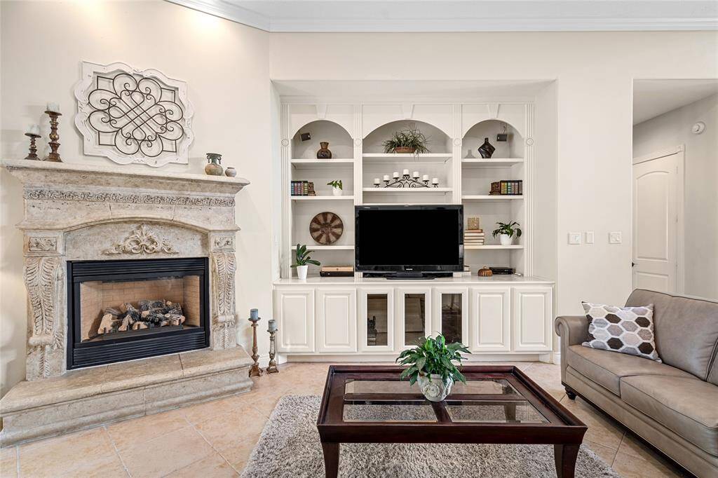 The living room will lead you to the guest bath and primary suite.
