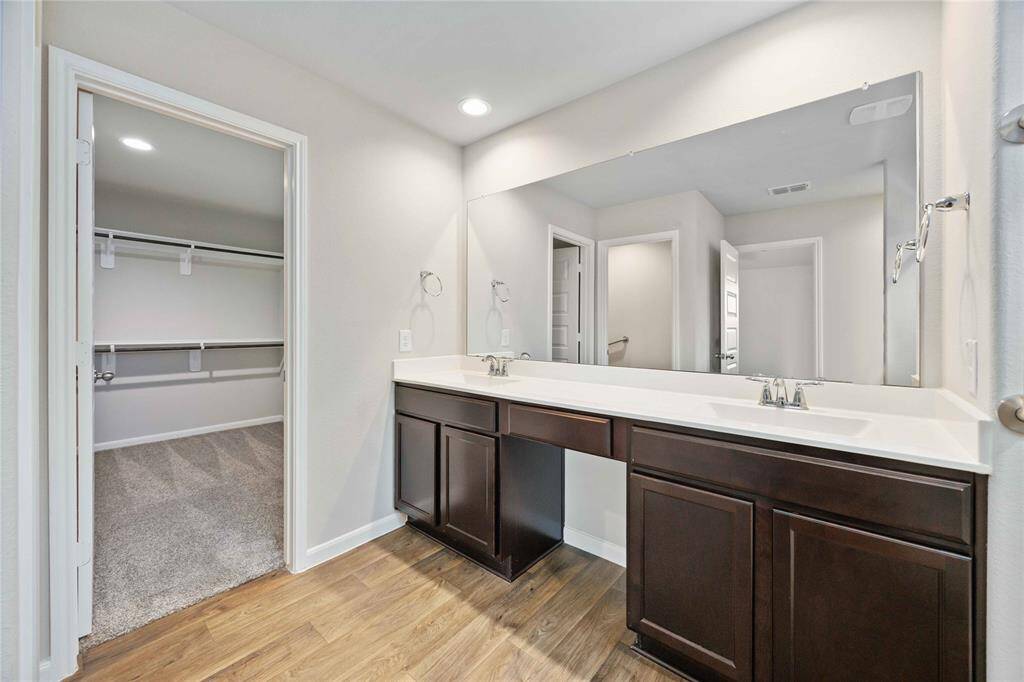 Access your oversized walk-in closet and shower through this stunning bathroom that includes double-sinks and a HUGE vanity mirror!