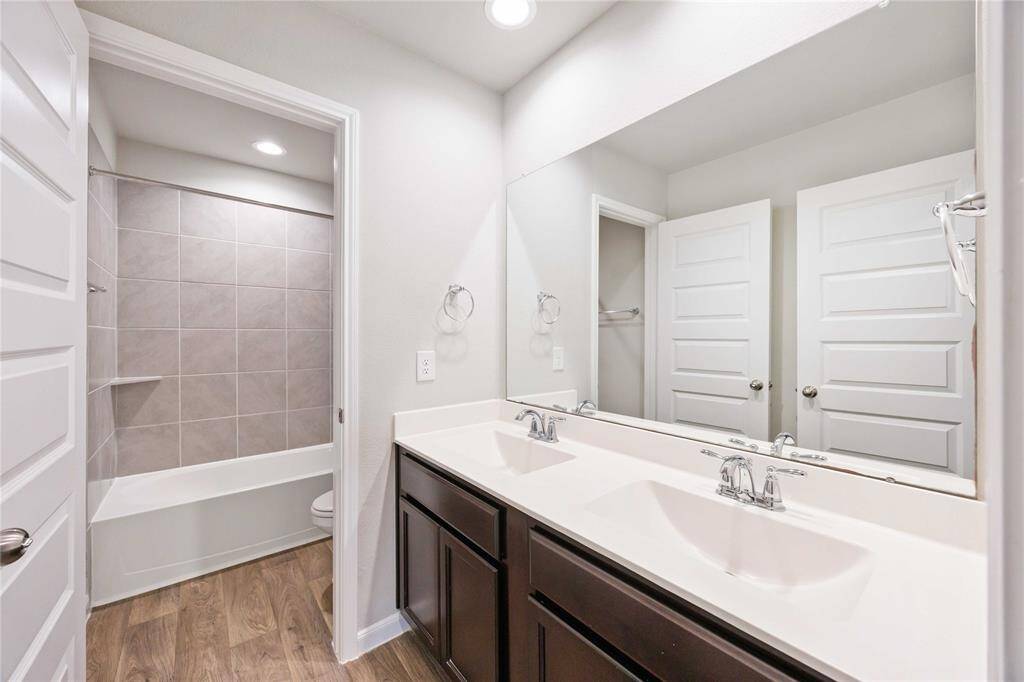 Double vanity, pristine countertops, and a spa-like shower. A perfect blend of function and style.
