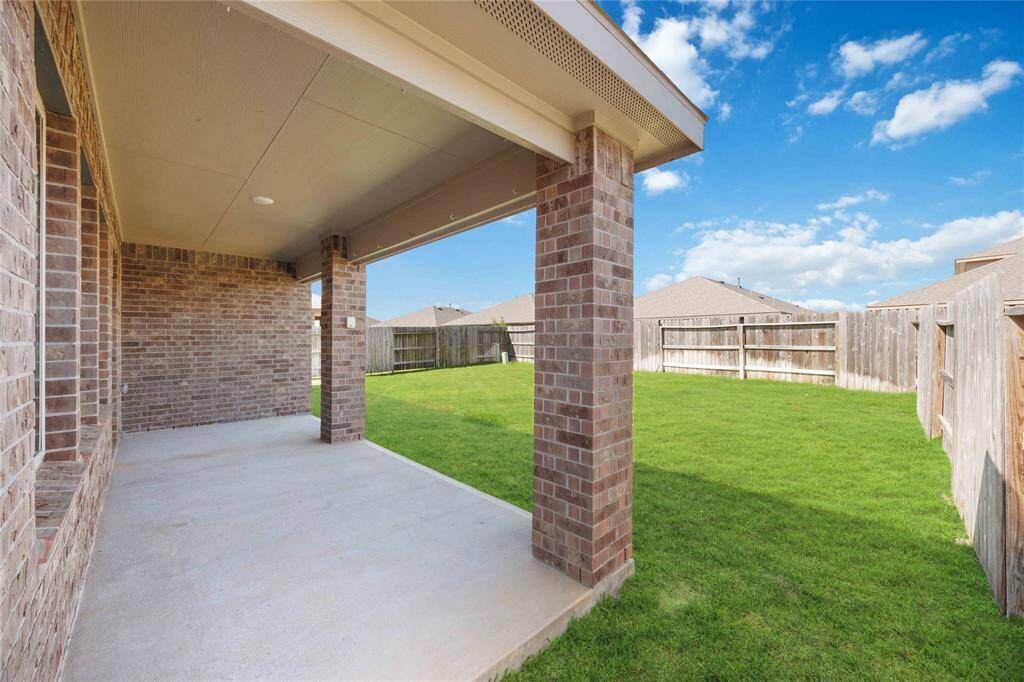 Backyard patio with built in lighting offers a sweet escape to the outdoors.