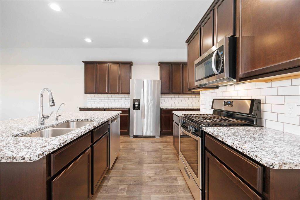 Stainless steel appliances shine in this bright and airy kitchen. A place to create memories.