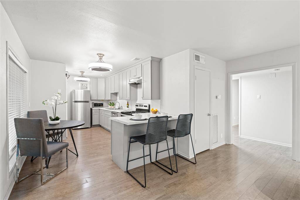 The living room and kitchen are joined seamlessly while a convenient breakfast bar separates the spaces.