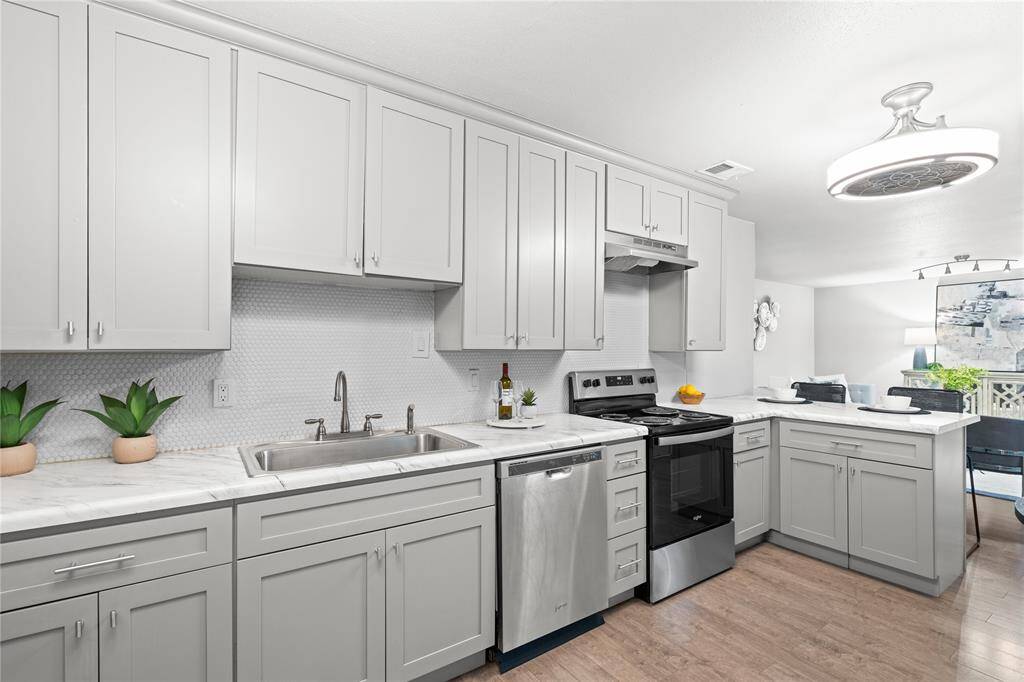The kitchen features soft close cabinets and drawers and stainless steel appliances including a refrigerator that conveys with the home.