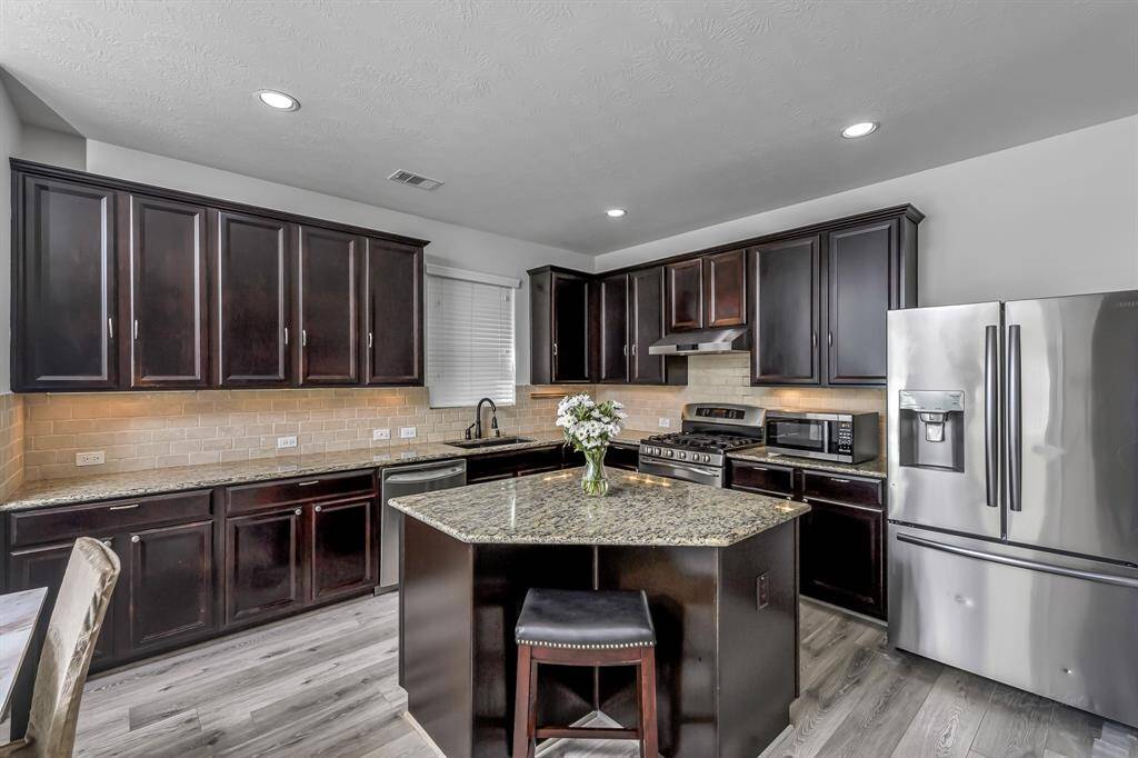 Spacious island kitchen with granite countertops
