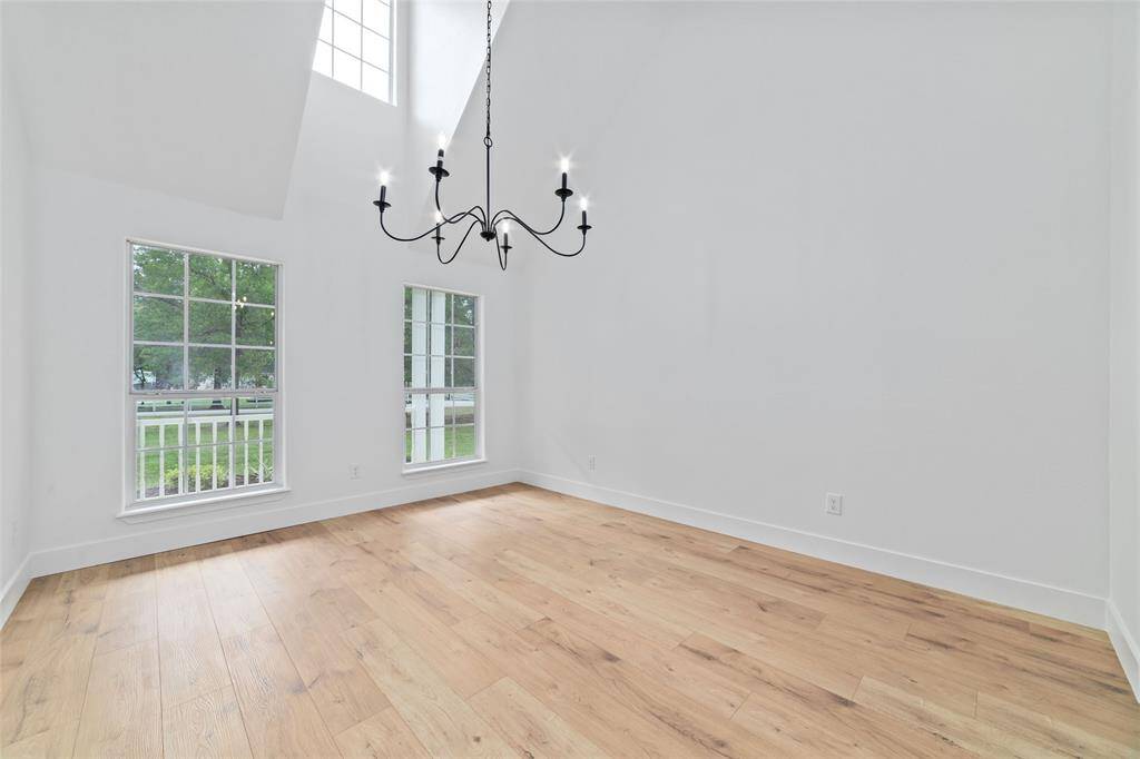 Elegant dining room with soaring cathedral ceilings and a stylish chandelier.
