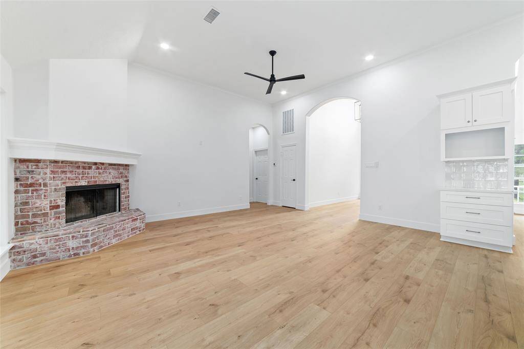 Cozy family room featuring a charming wood-burning fireplace.