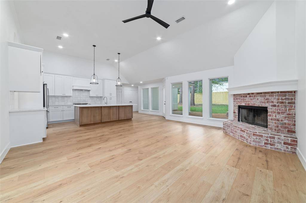 Spacious entertaining area with a cozy corner fireplace.