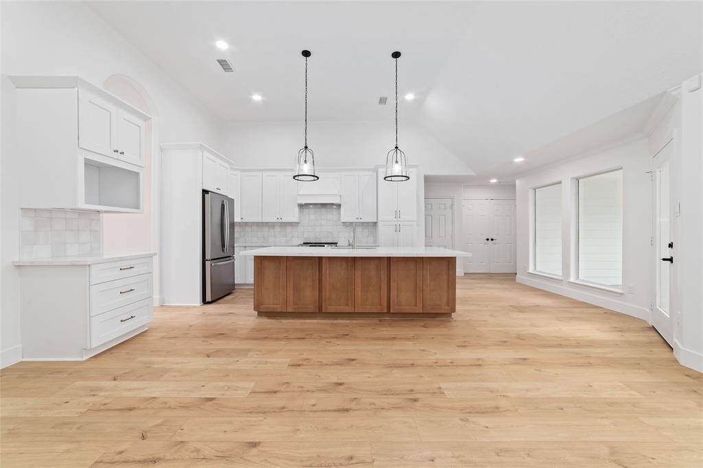 Spacious and sunlit kitchen with a large, inviting island.